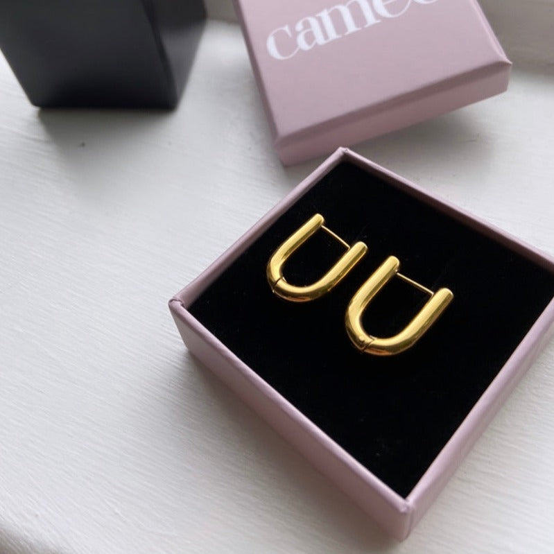 demi gold oval huggie earrings